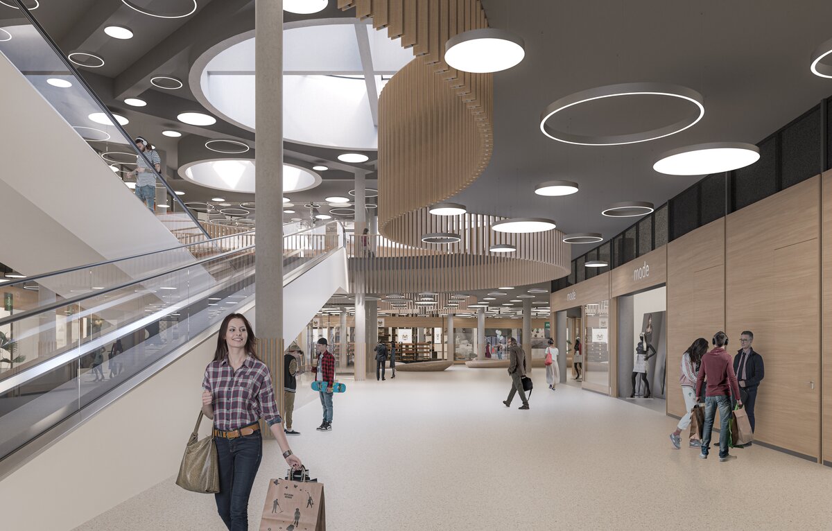 Innenansicht des Neubaus Oberland Märt mit Mall, Rolltreppe und Geschäften.
